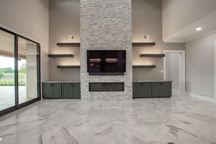 A living room with a fireplace and a flat screen tv on the wall.