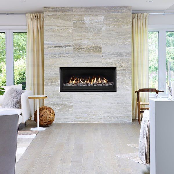 A living room with a fireplace built into the wall