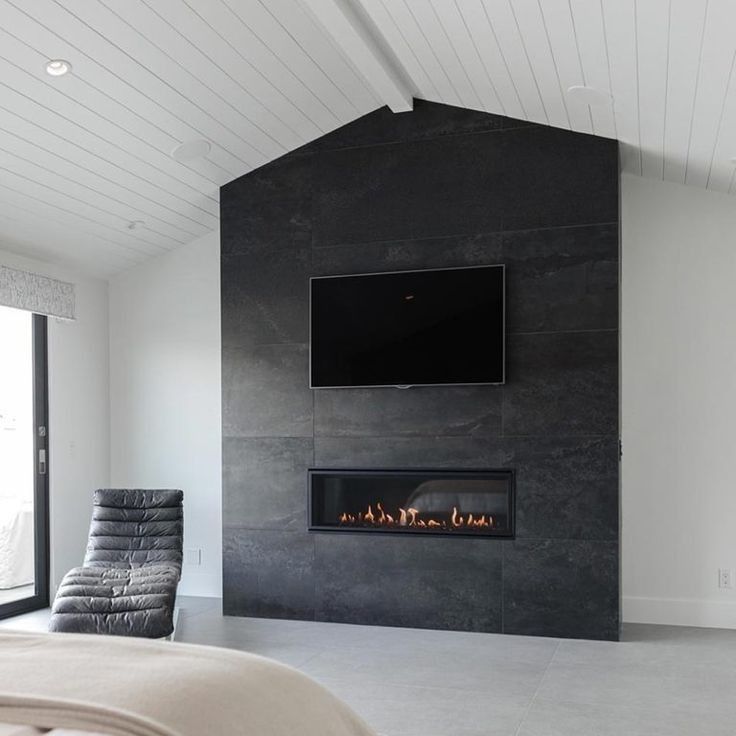 A bedroom with a fireplace and a flat screen tv