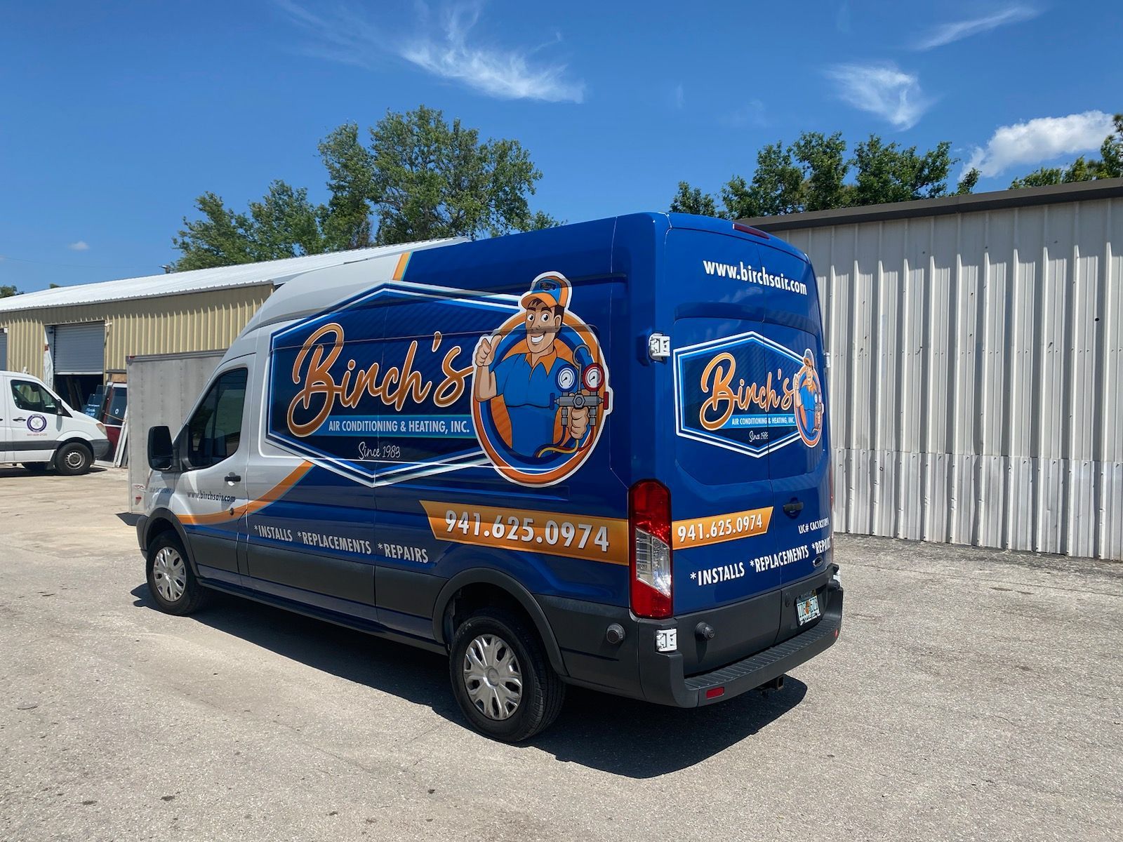 Technician kneels beside HVAC unit, working on wiring tools and cables outdoors.