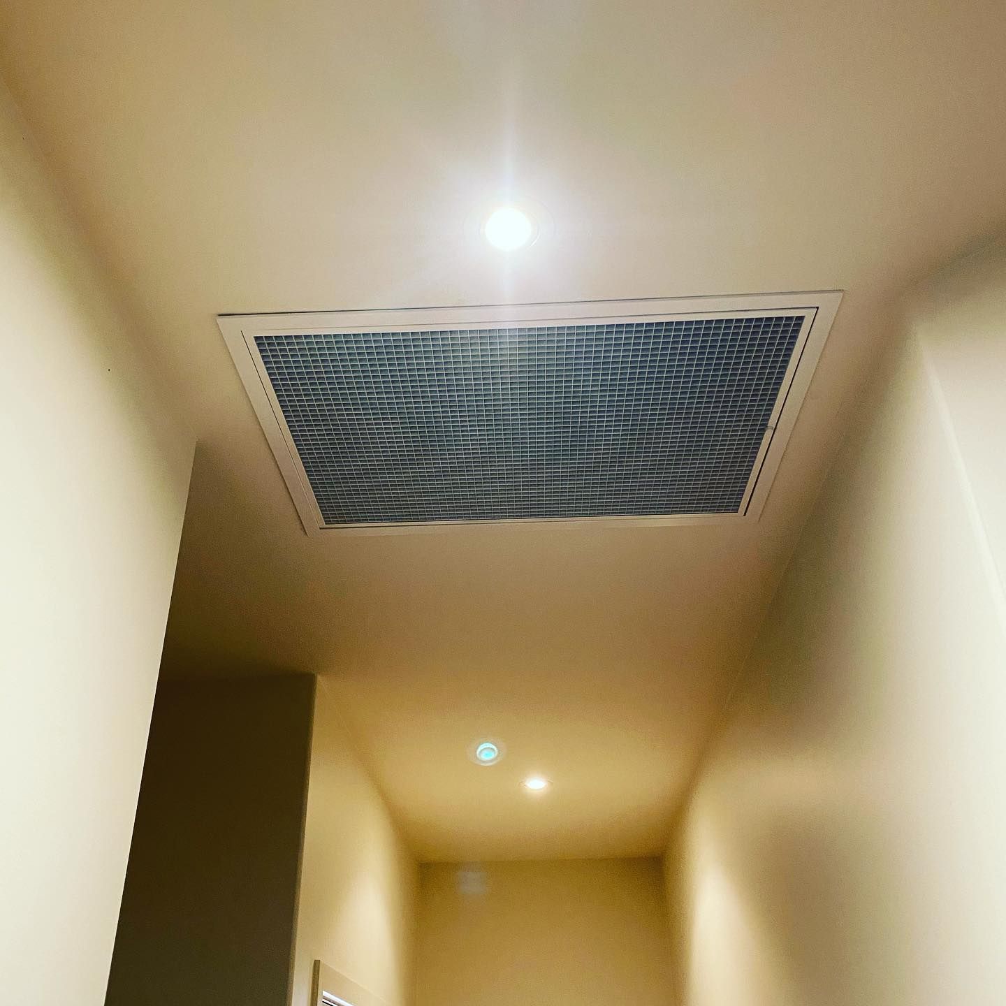 Ceiling Vent in a Hallway With a Recessed Light Fixture; Tan Walls and Ceiling — Airset Air Conditioning in Bellingen, NSW