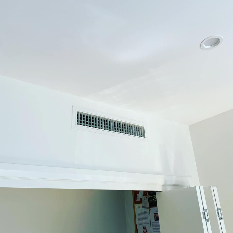 White Ceiling and Wall With a Rectangular Hvac Vent and Recessed Light — Airset Air Conditioning in Urunga, NSW