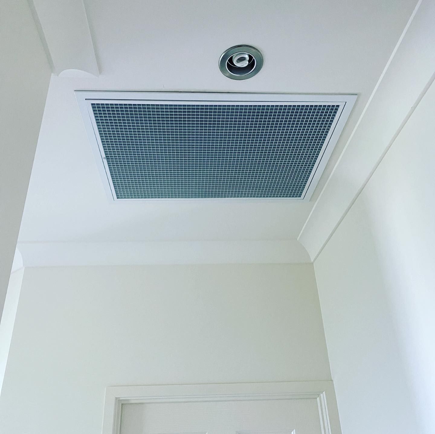 Ceiling Air Vent and Recessed Light Fixture in a White Hallway — Airset Air Conditioning in Bonville, NSW
