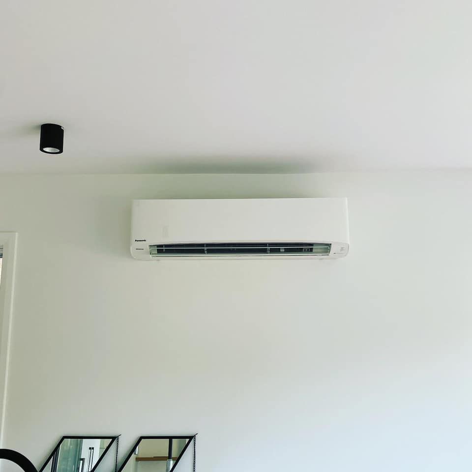 White Wall-mounted Air Conditioning Unit on a White Wall — Airset Air Conditioning in Urunga, NSW