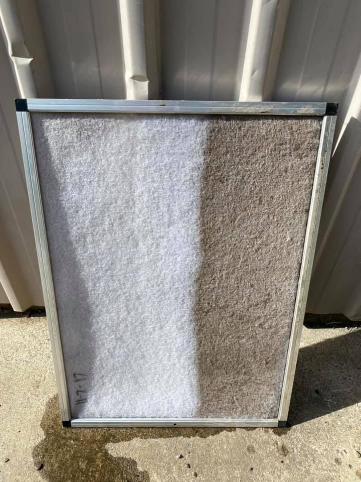 Person Spraying an Outdoor Air Conditioner Unit With a Hose — Airset Air Conditioning in Urunga, NSW