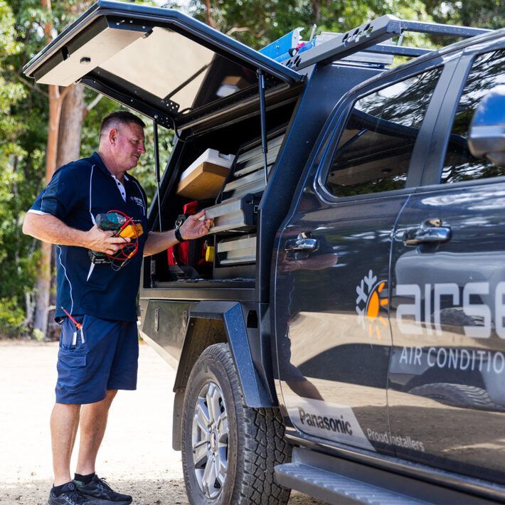 Electrician accessing tools in work ute — Airset Air Conditioning in Bonville, NSW