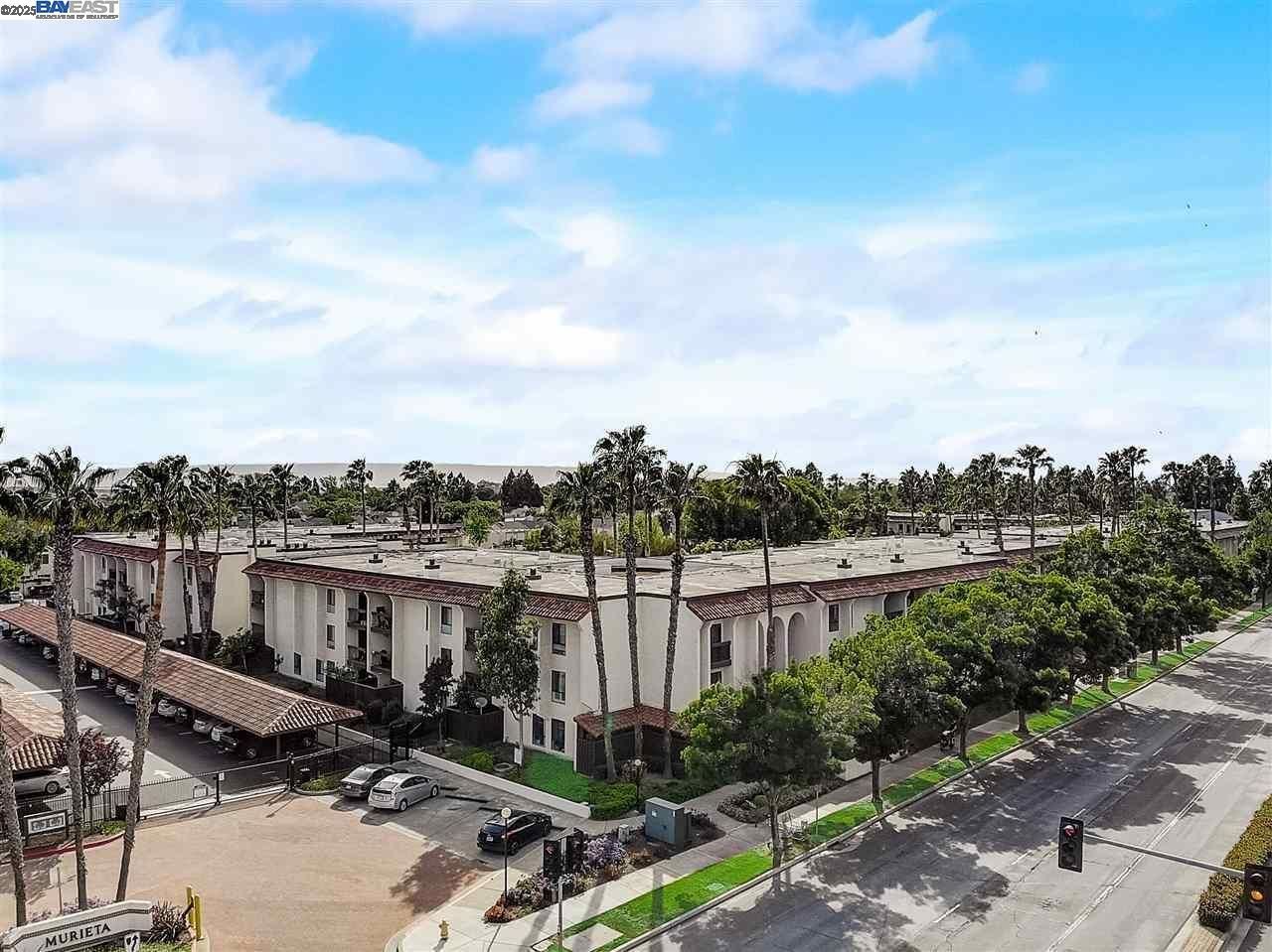An aerial view of a residential area with lots of buildings and palm trees.