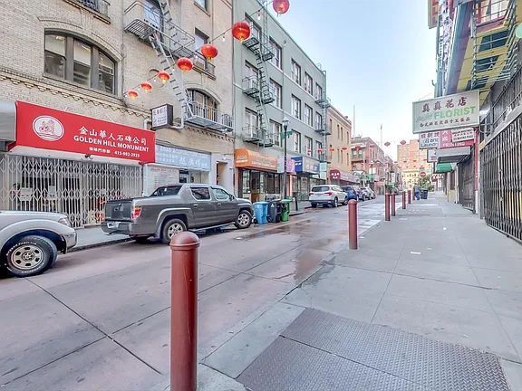 A truck is parked on the side of a city street.