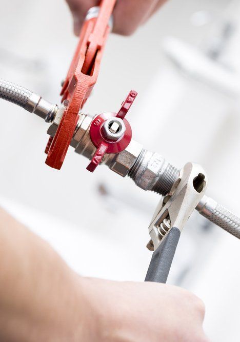 Plumber Screwing Plumbing Fittings in Bathroom — Plumbing in Kingscliff, NSW