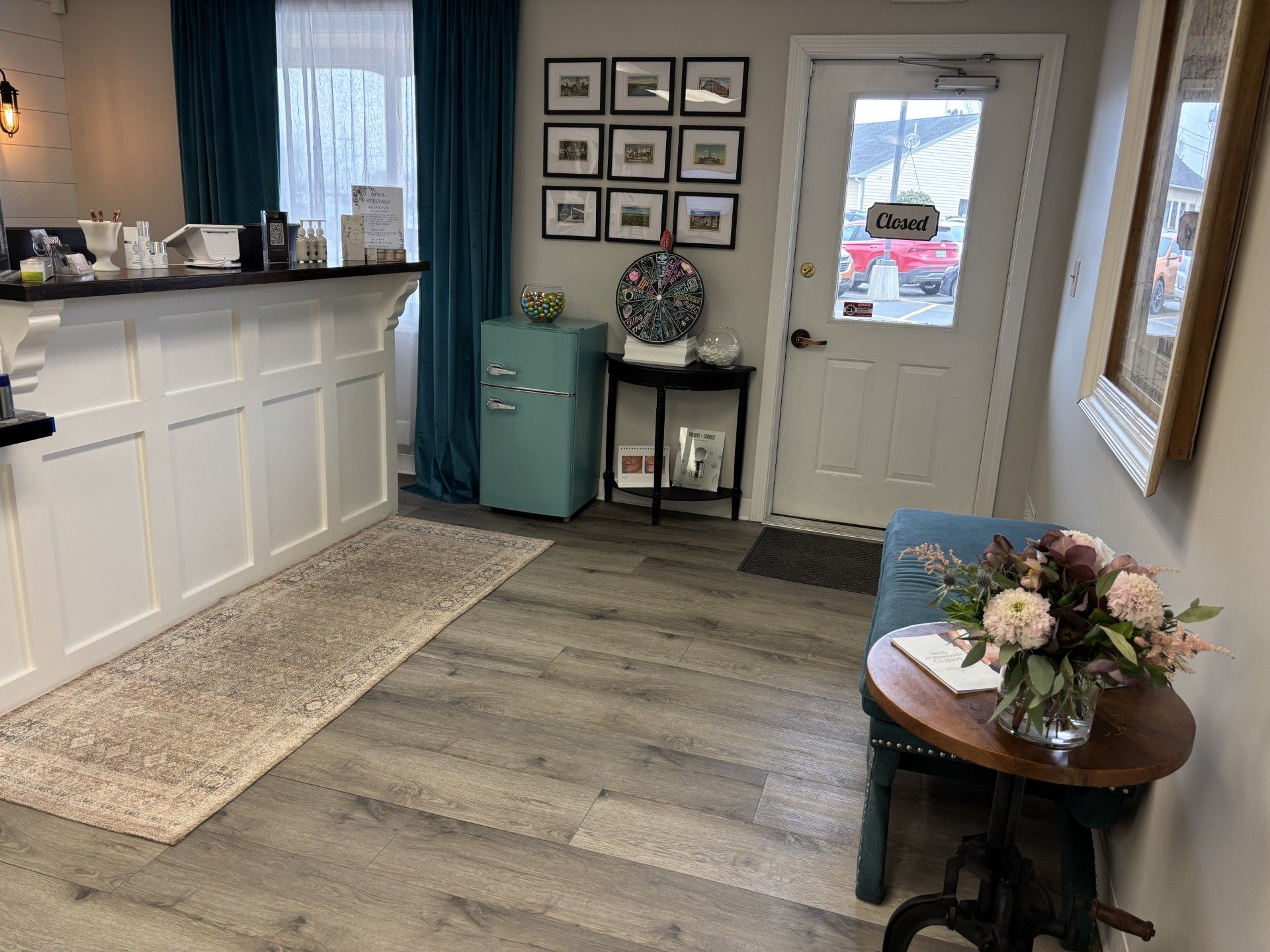There is a table with flowers on it in the middle of the room.