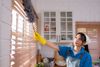 woman cleaning blinds