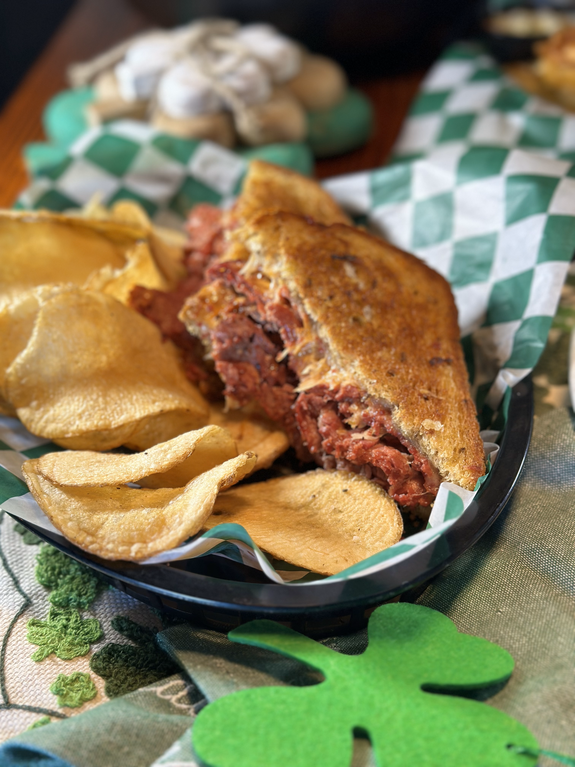 A sandwich and chips in a basket on a table