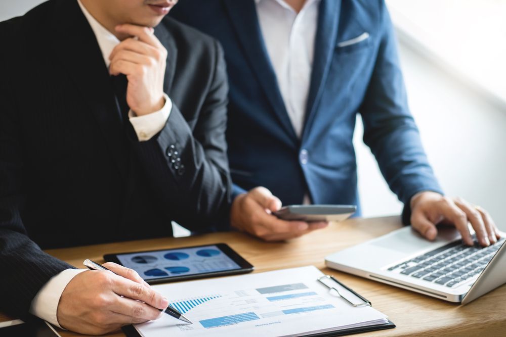 Two Men With a Laptop and a Tablet — Townsville Accounting In Hyde Park, QLD