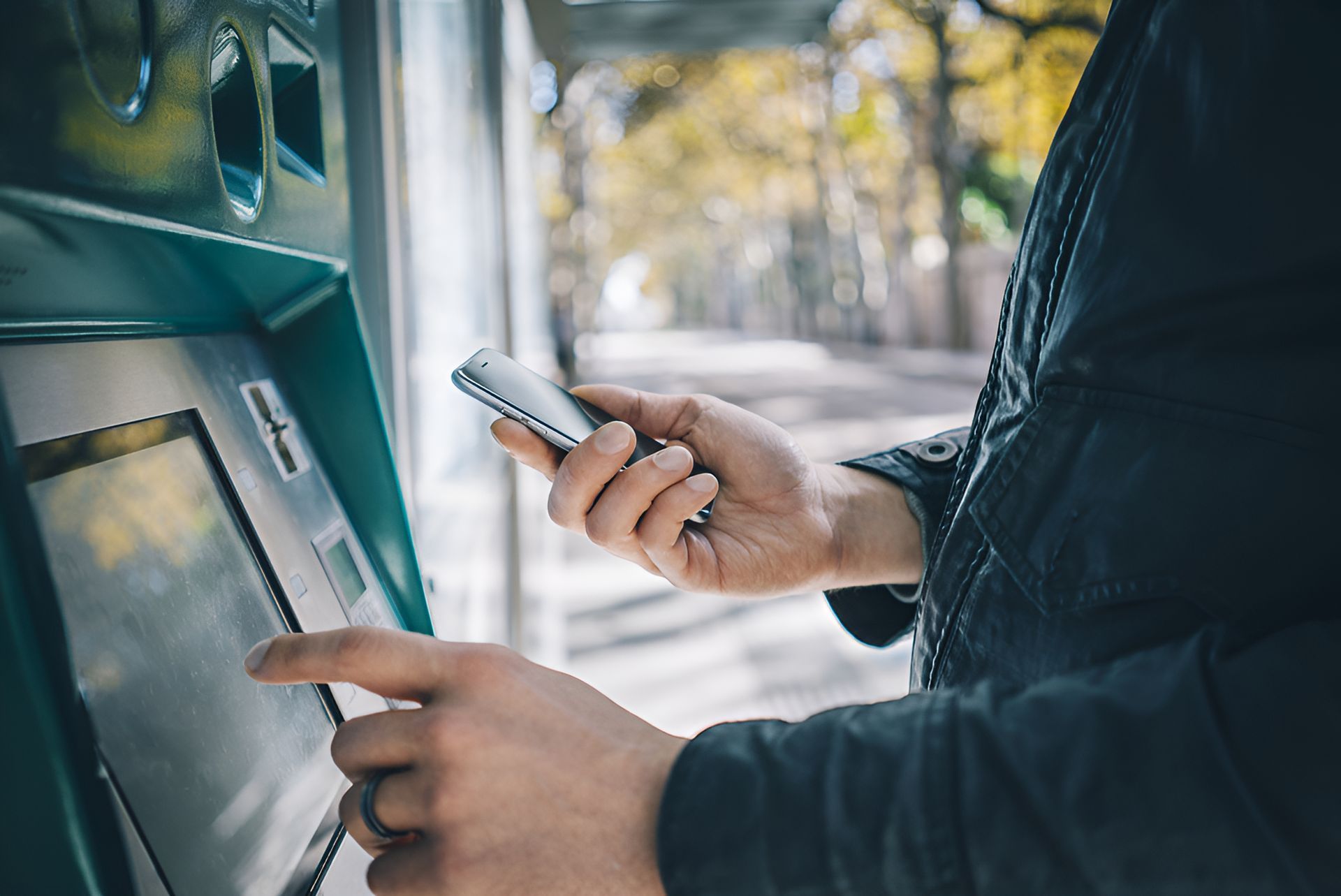 A Person is Using a Cell Phone at an Atm Machine — Townsville Accounting In Hyde Park, QLD