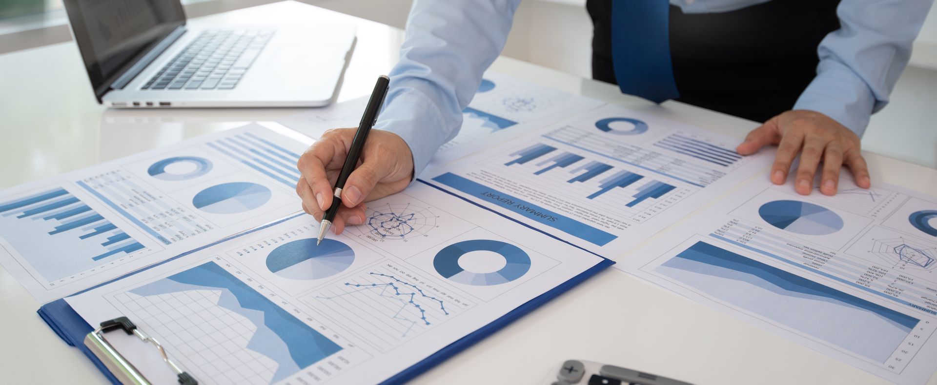 A Man is Looking at Graphs and Charts — Townsville Accounting In Hyde Park, QLD
