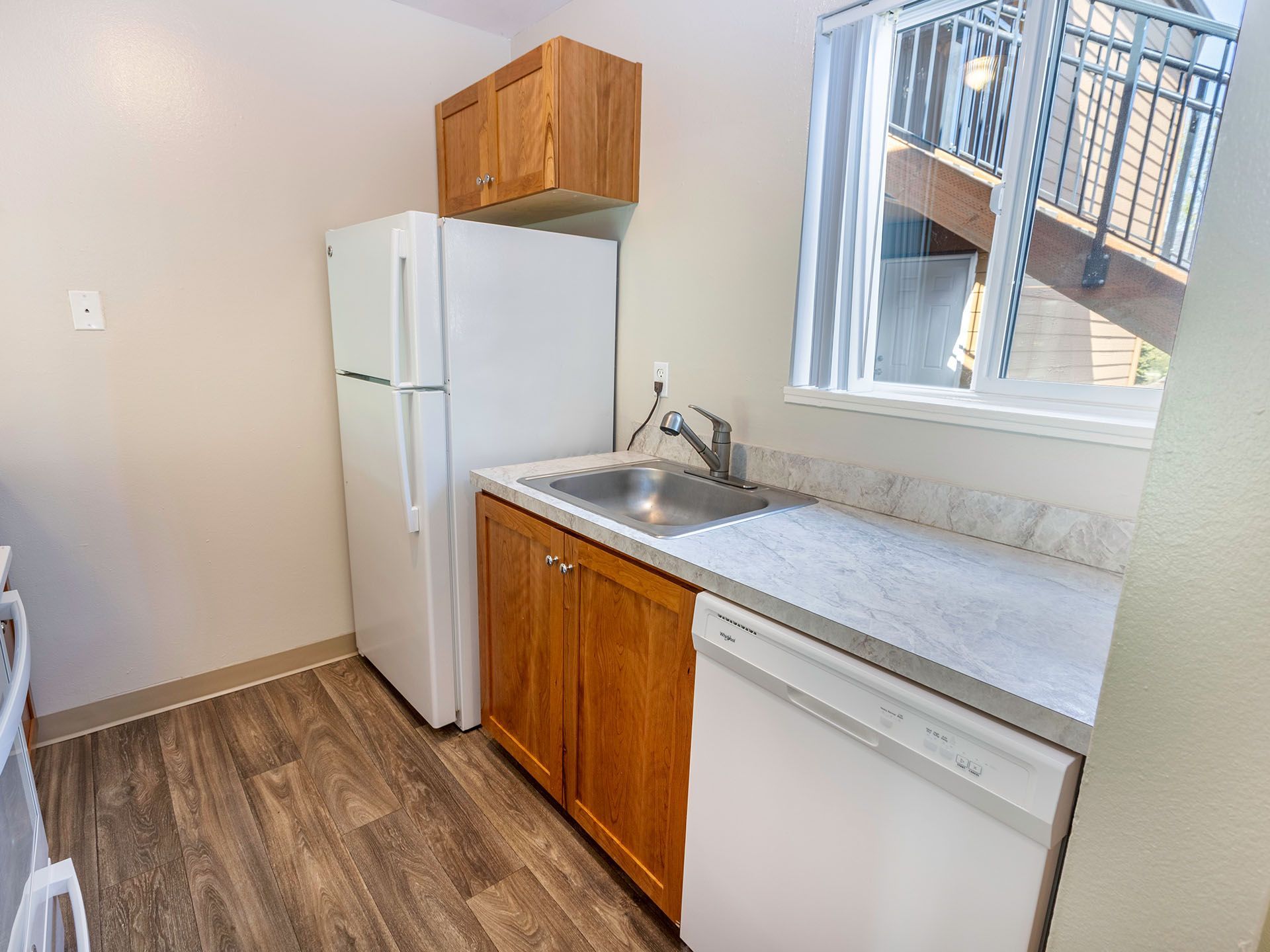 Photo of a kitchen with a view of the community steps seen from the window