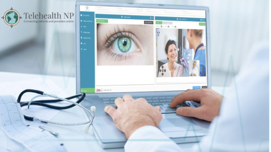 Person using laptop for telehealth. The screen shows a magnified eye and a video call with healthcare providers. Stethoscope on desk.