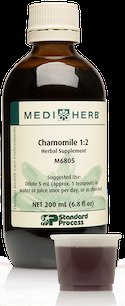 Bottle of MediHerb Chamomile 1:2 with a small cup filled with a dark liquid.