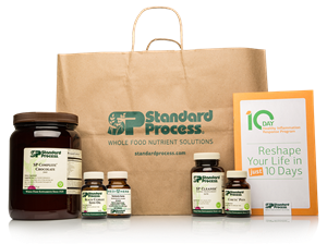 Brown bag with Standard Process products: jar, bottles, and a guide.