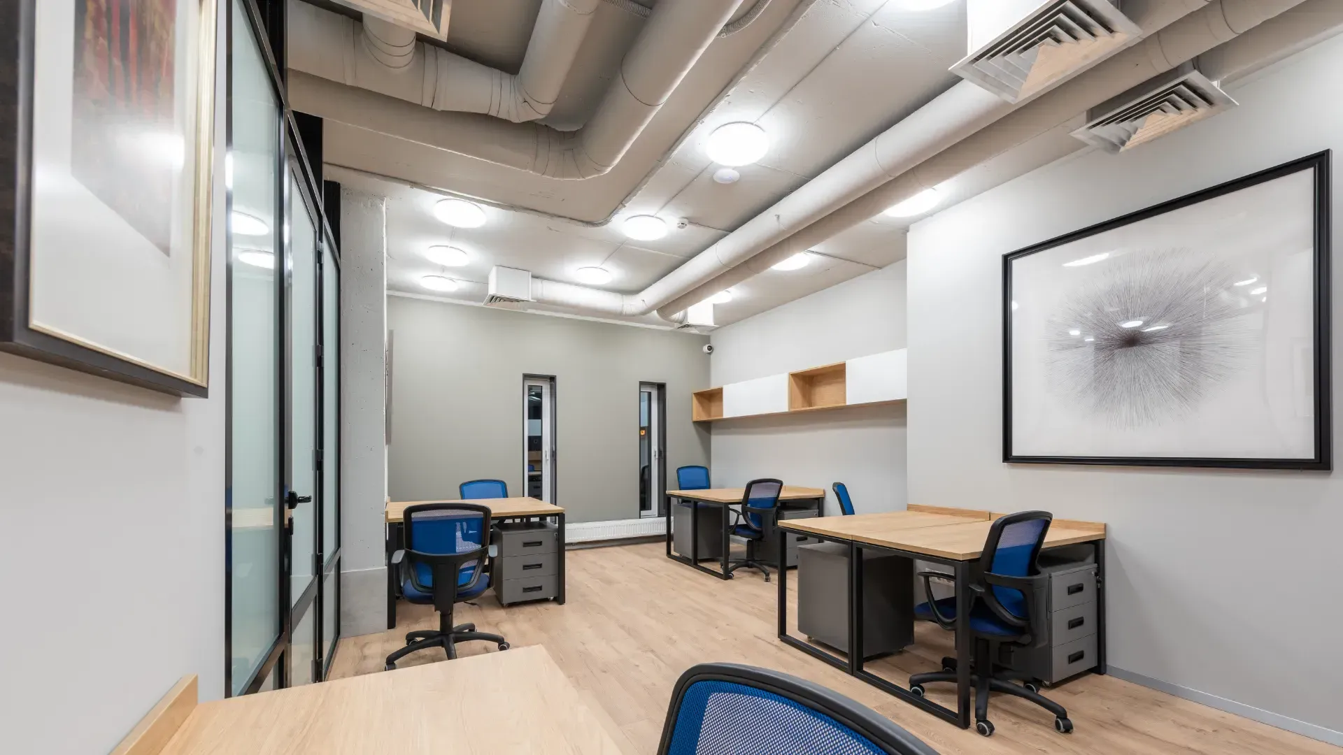 A room with a lot of desks and chairs in it.