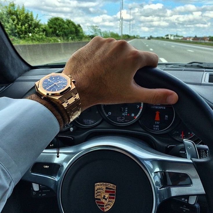 Men driving a porcshe wearing audemars piguet luxury watch