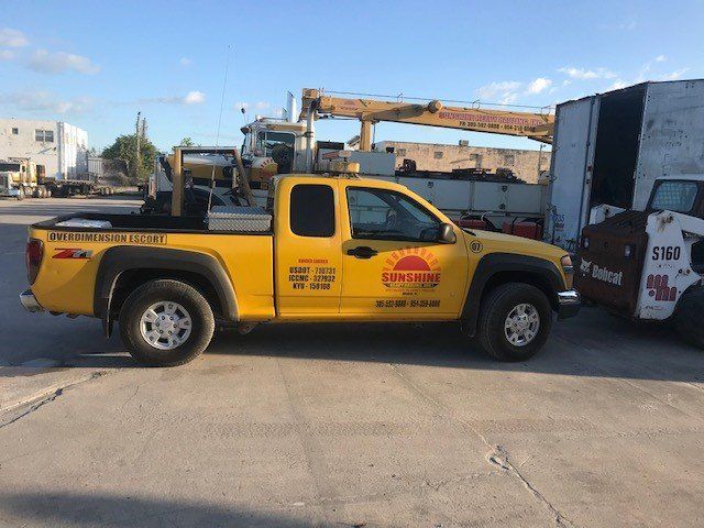 Yellow Car on Site — Opa-locka, FL — Sunshine Heavy Hauling, Inc.