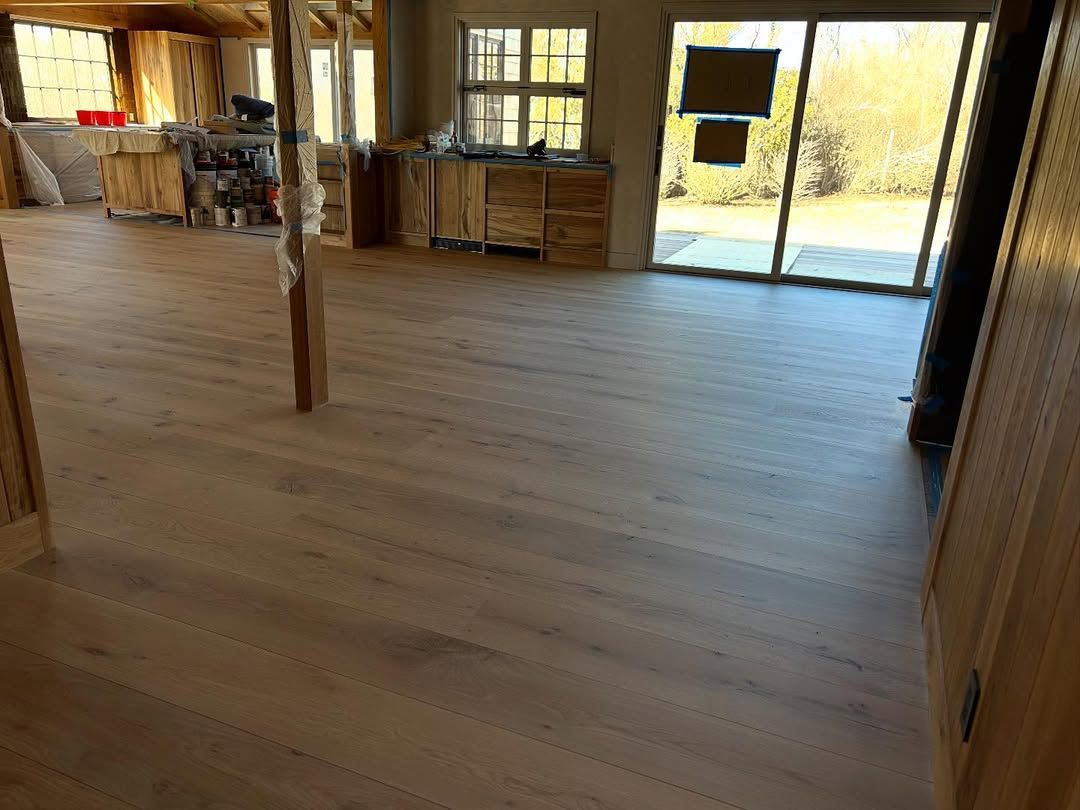 A large room with a wooden floor and sliding glass doors.