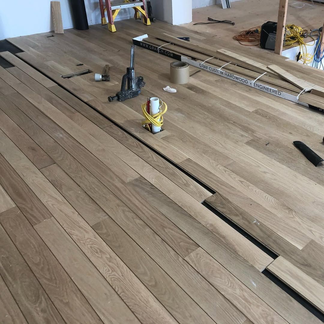 A wooden floor is being installed in a room.