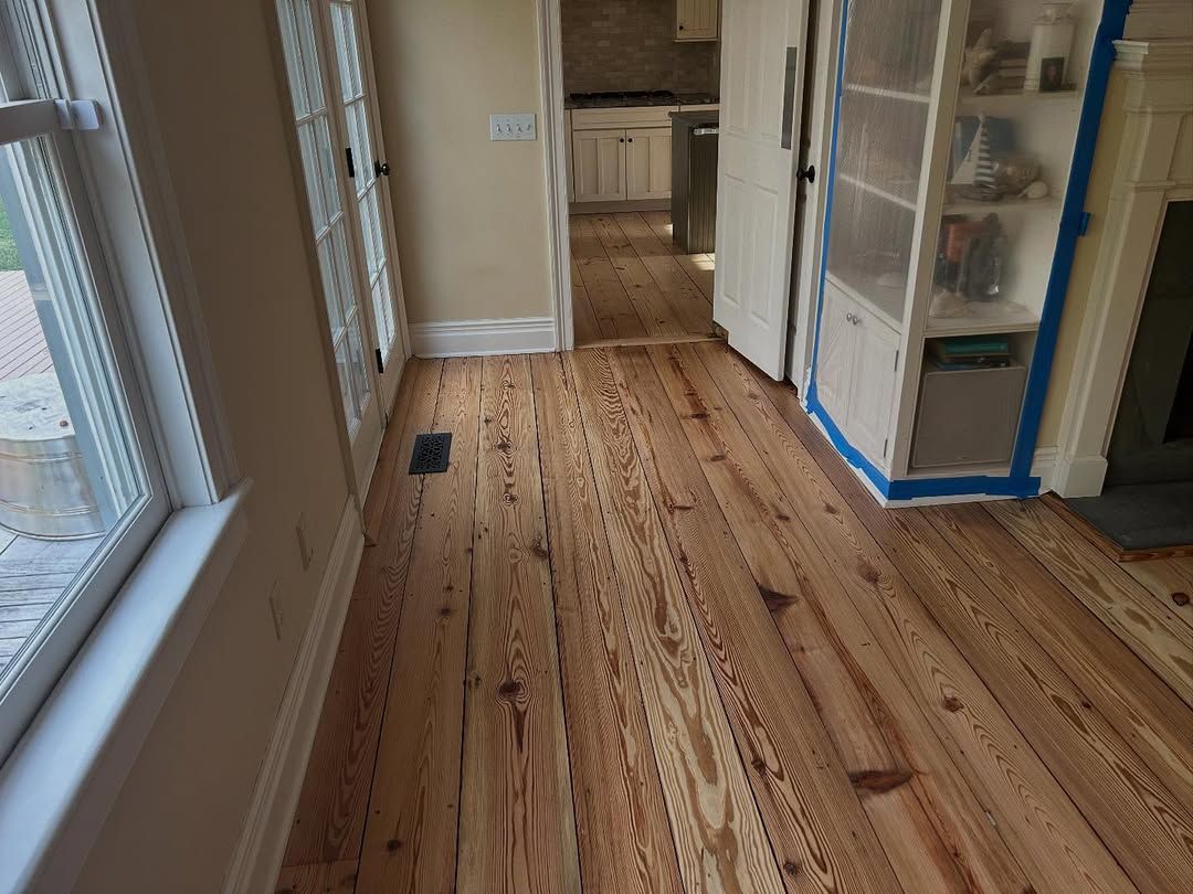 A room with a wooden floor and a window.