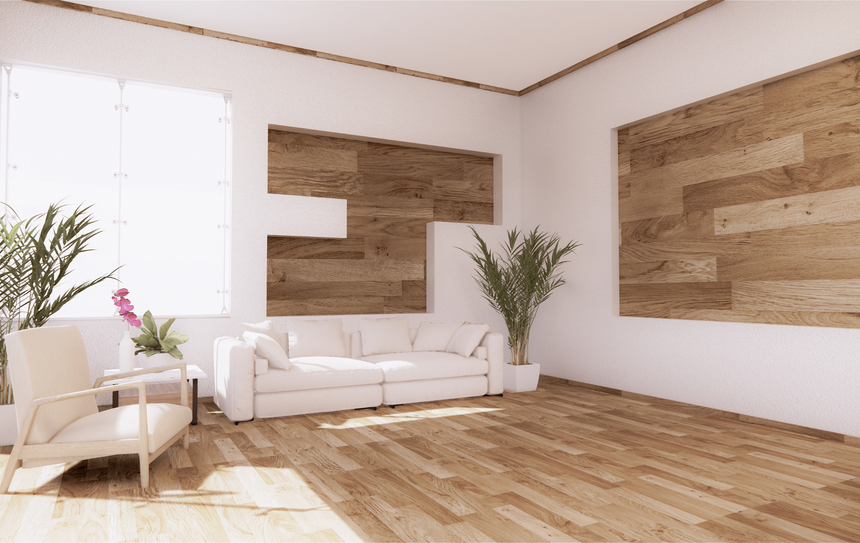 A living room with a white couch , chair , and wooden floor.
