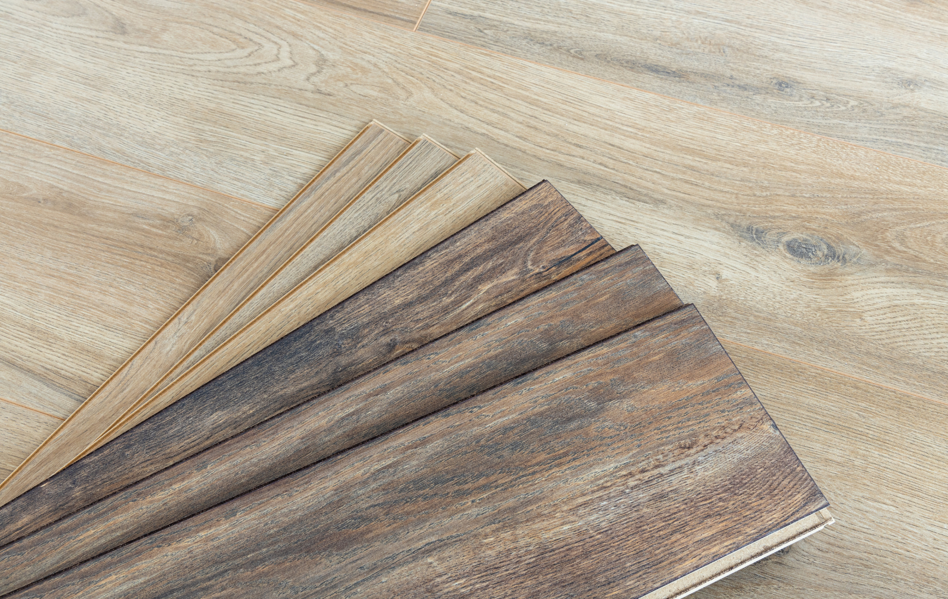 A close up of a stack of wooden boards on a wooden floor.