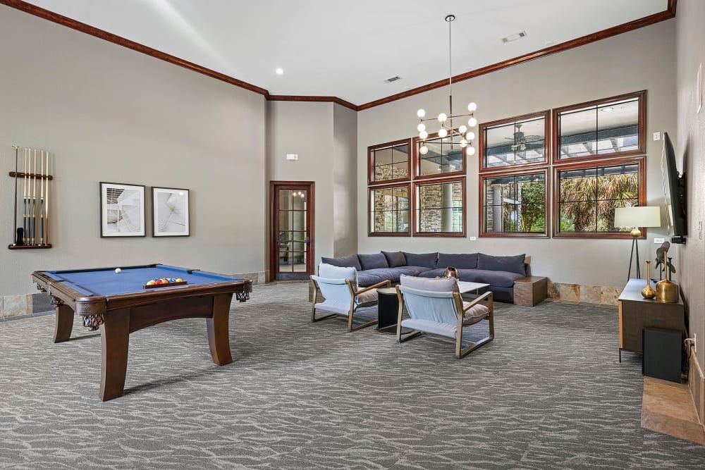 a pool table in the middle of the room in the clubhouse at Marquis Parkside in Austin, TX.