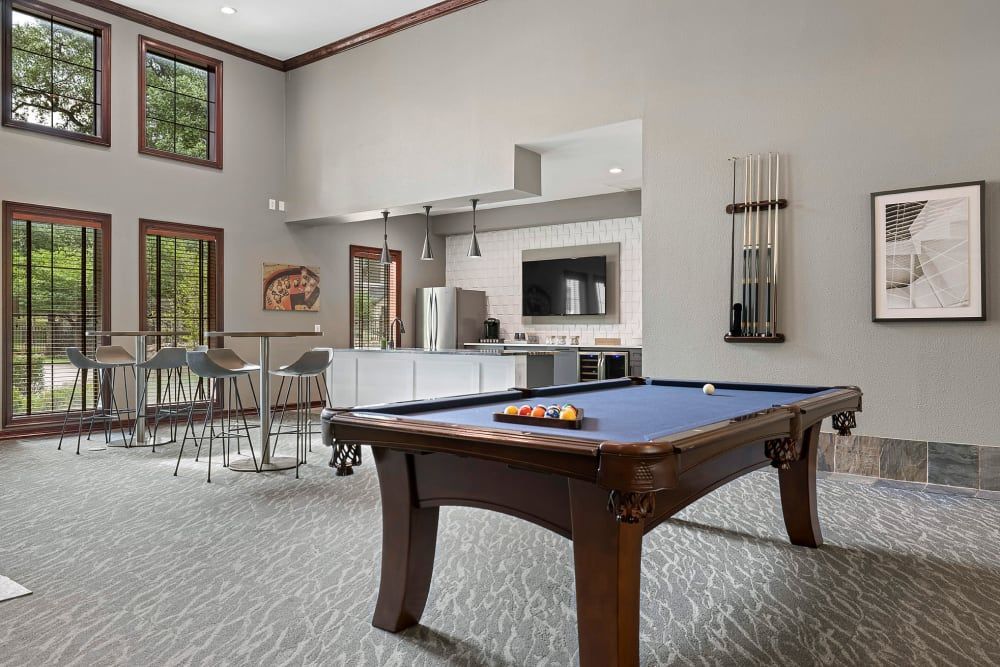 a pool table in the middle of the room at Marquis Parkside in Austin, TX.