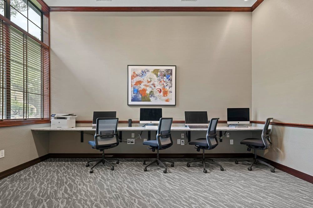 a room with a lot of computers and chairs in it at Marquis Parkside in Austin, TX.