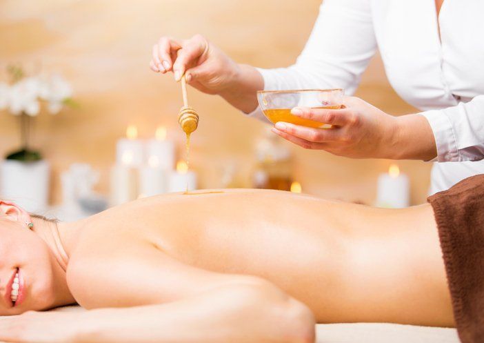 Body Shaping — Woman Gives Honey Body Treatment in West Springfield, MA