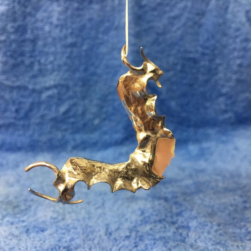 A Piece of Gold Hanging from a String on a Blue Cloth | Lismore, NSW | Active Denture Clinic