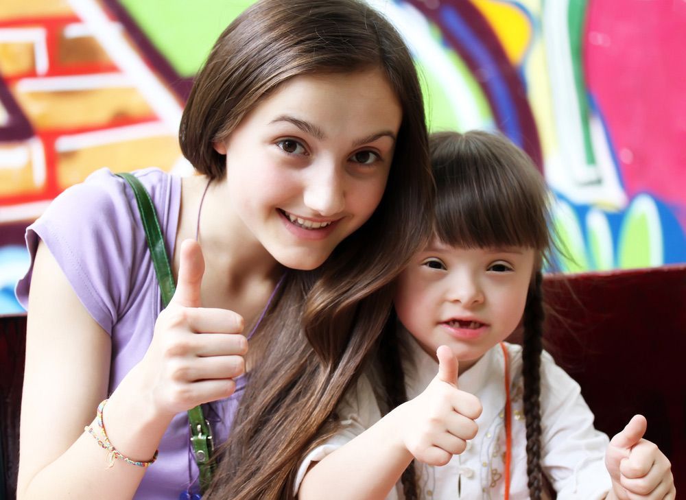 A Girl and a Little girl are Giving a Thumbs up — Adaptive Care Pty Ltd In Tarneit, VIC