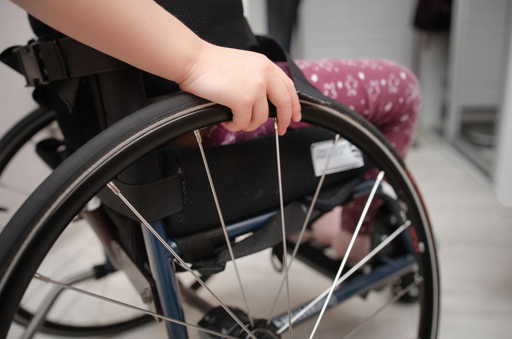 Close-Up Hand of a Child on a Wheel from a Wheelchair — Adaptive Care Pty Ltd In Tarneit, VIC