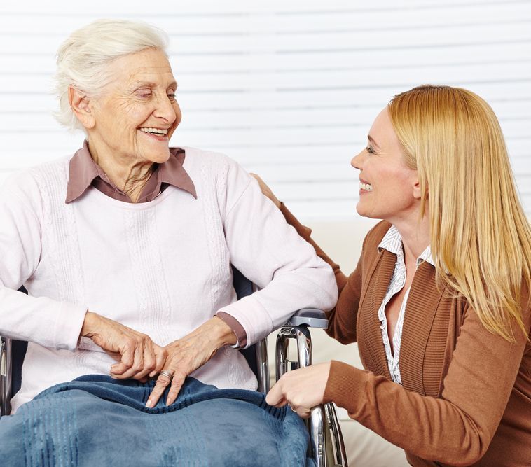 A Woman is Talking to an Elderly Woman in a Wheelchair — Adaptive Care Pty Ltd In Tarneit, VIC