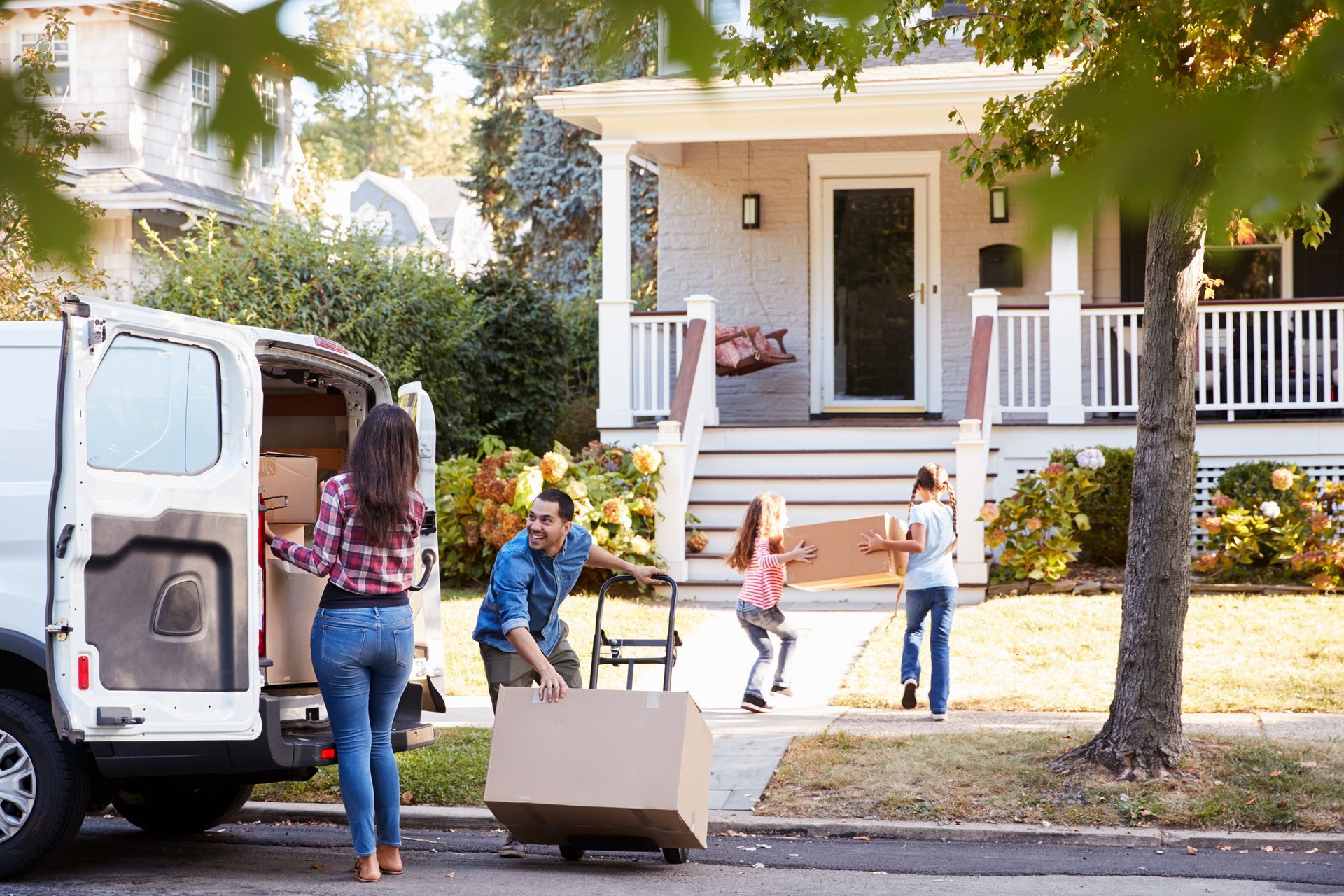 Children Helping Unload Boxes From Van On Family Moving In Day ©MonkeyBusinessImages