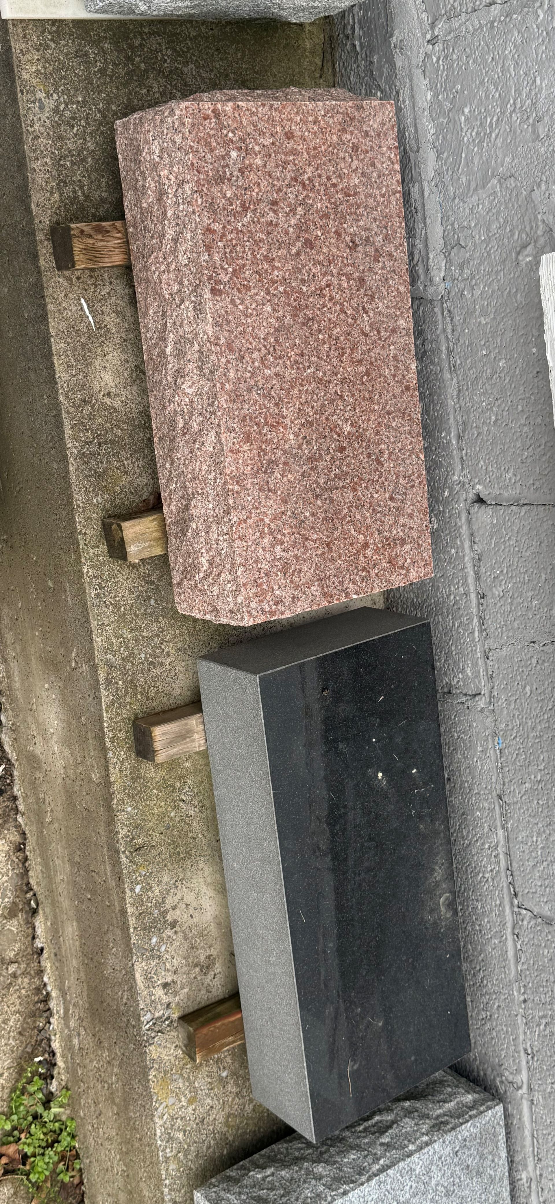A stack of bricks sitting on top of each other on a sidewalk.