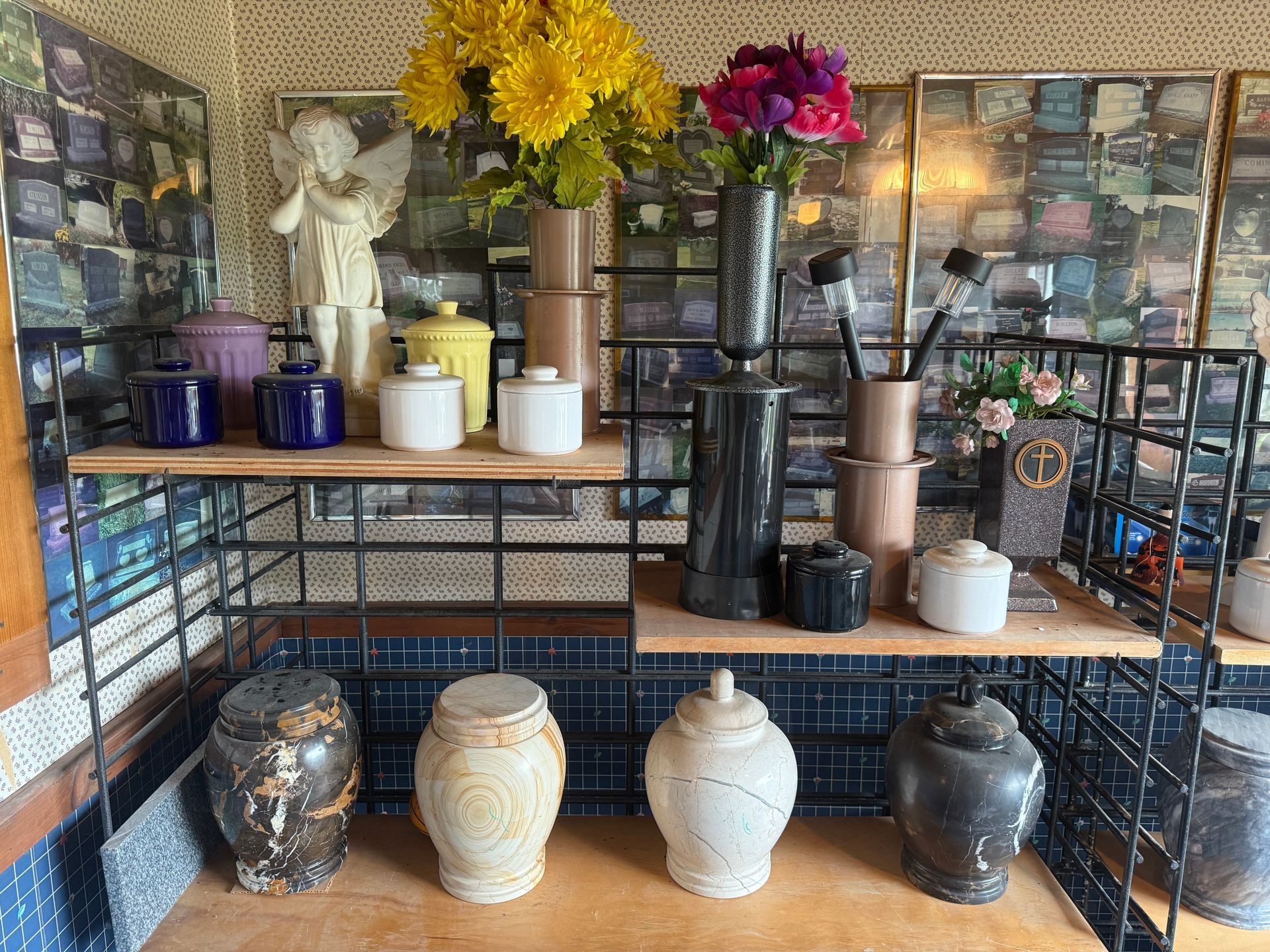 A table with a lot of vases and flowers on it.