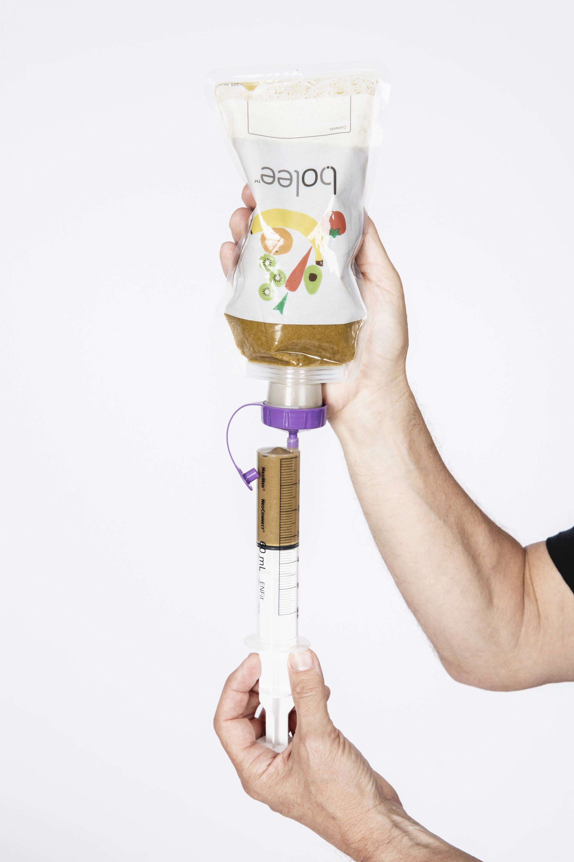 60ml enfit syringe being filled using the Bolee Bag