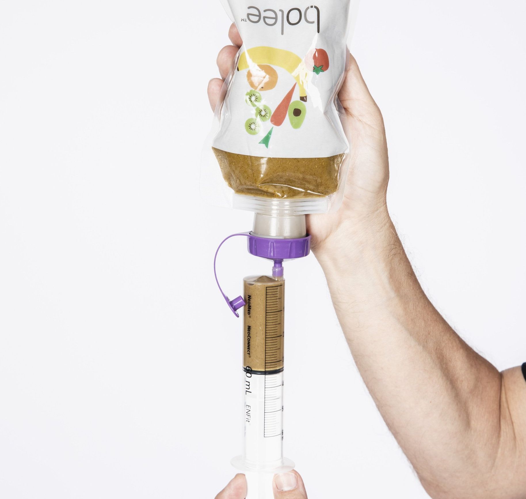 ENFit syringe being filled using a Bolee Bag and ENFit transfer lid