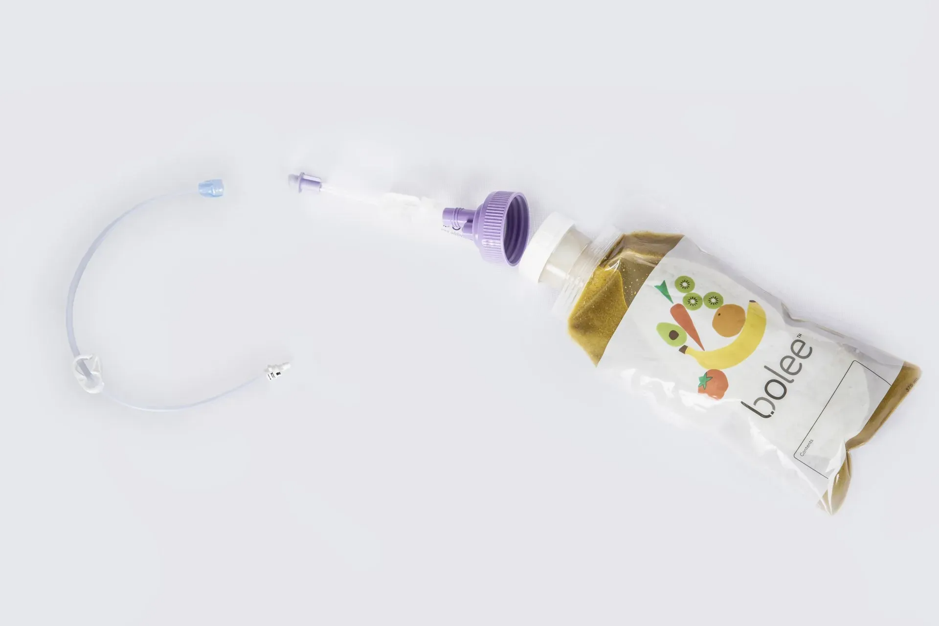 Filled Bolee Bag next to a Bolink Large Cap and bolus extension set