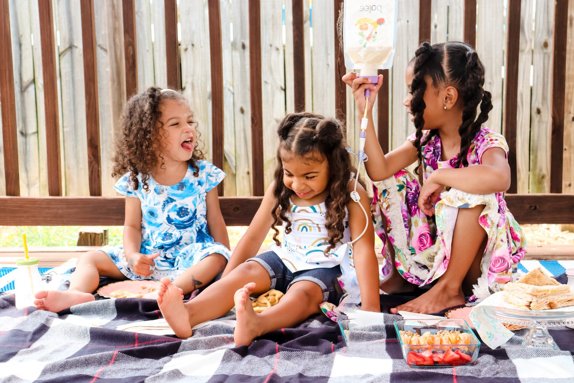 Three young girls with one holding the Bolee Bag
