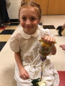 Young person holding the Bolee Bag while tube feeding