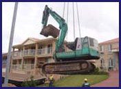 Excavator and bobcat lifted