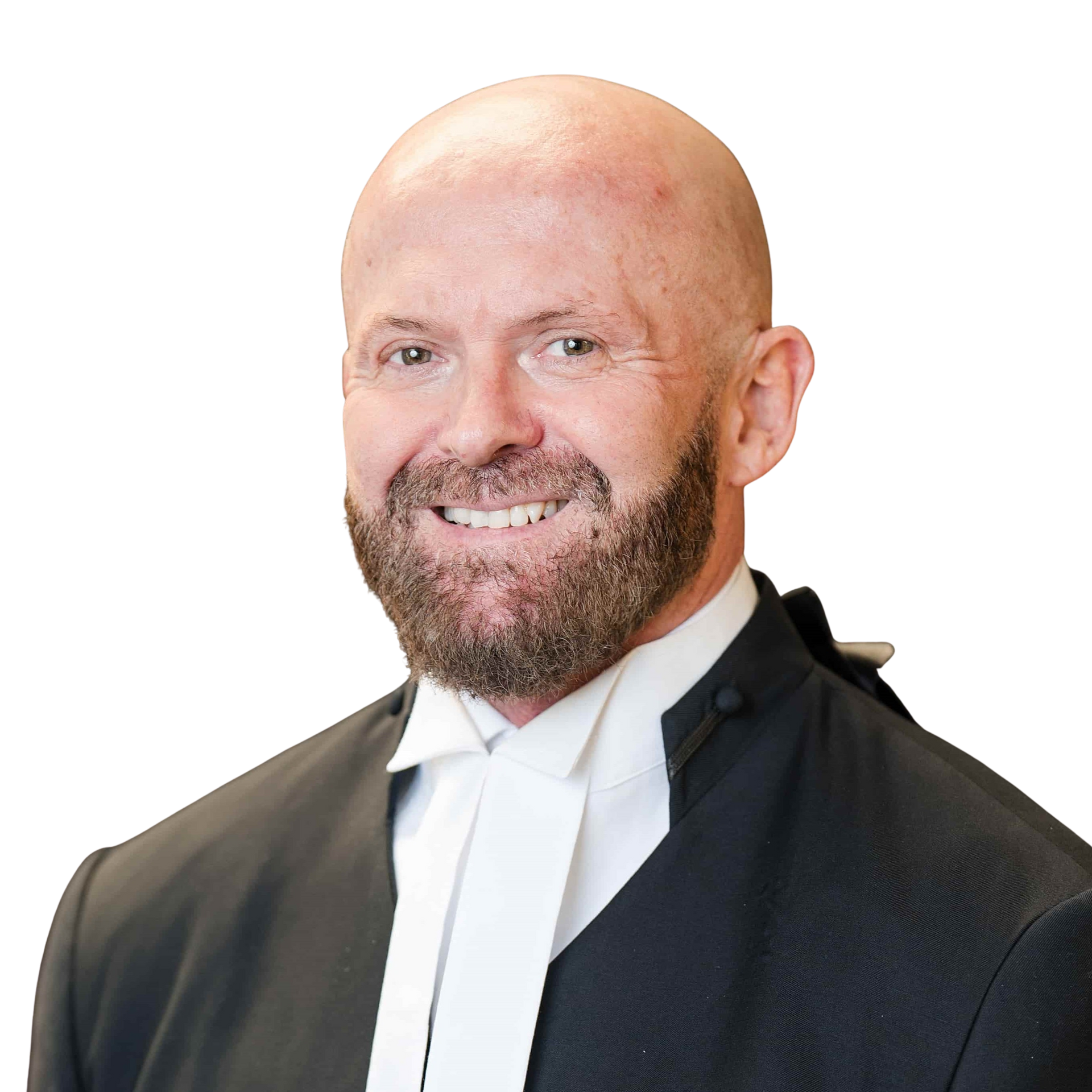 A man wearing glasses and a tuxedo is smiling for the camera.