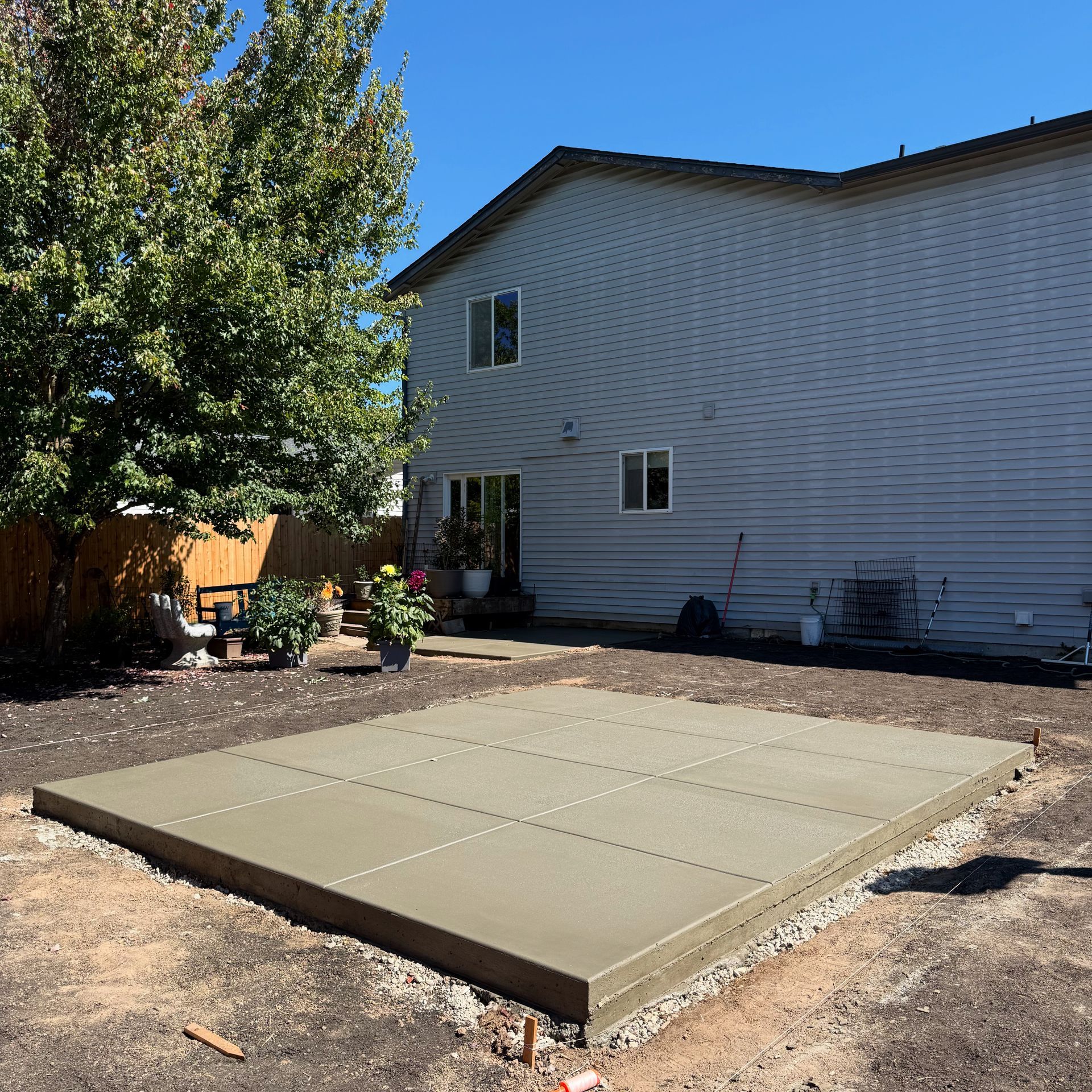 A row of houses with a white picket fence in a residential neighborhood.
